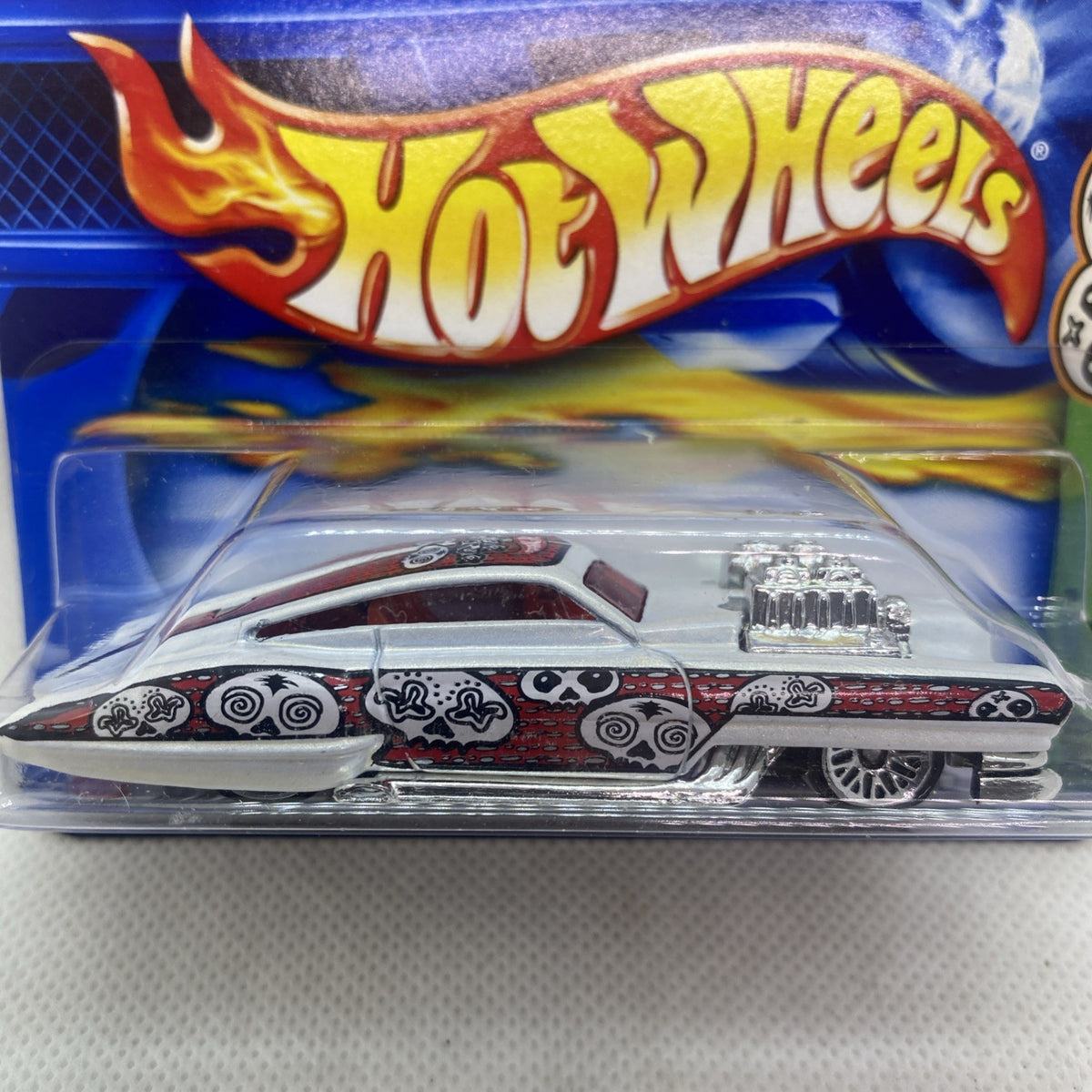 Hot Wheels die-cast car in blister packaging, close-up of car and logo