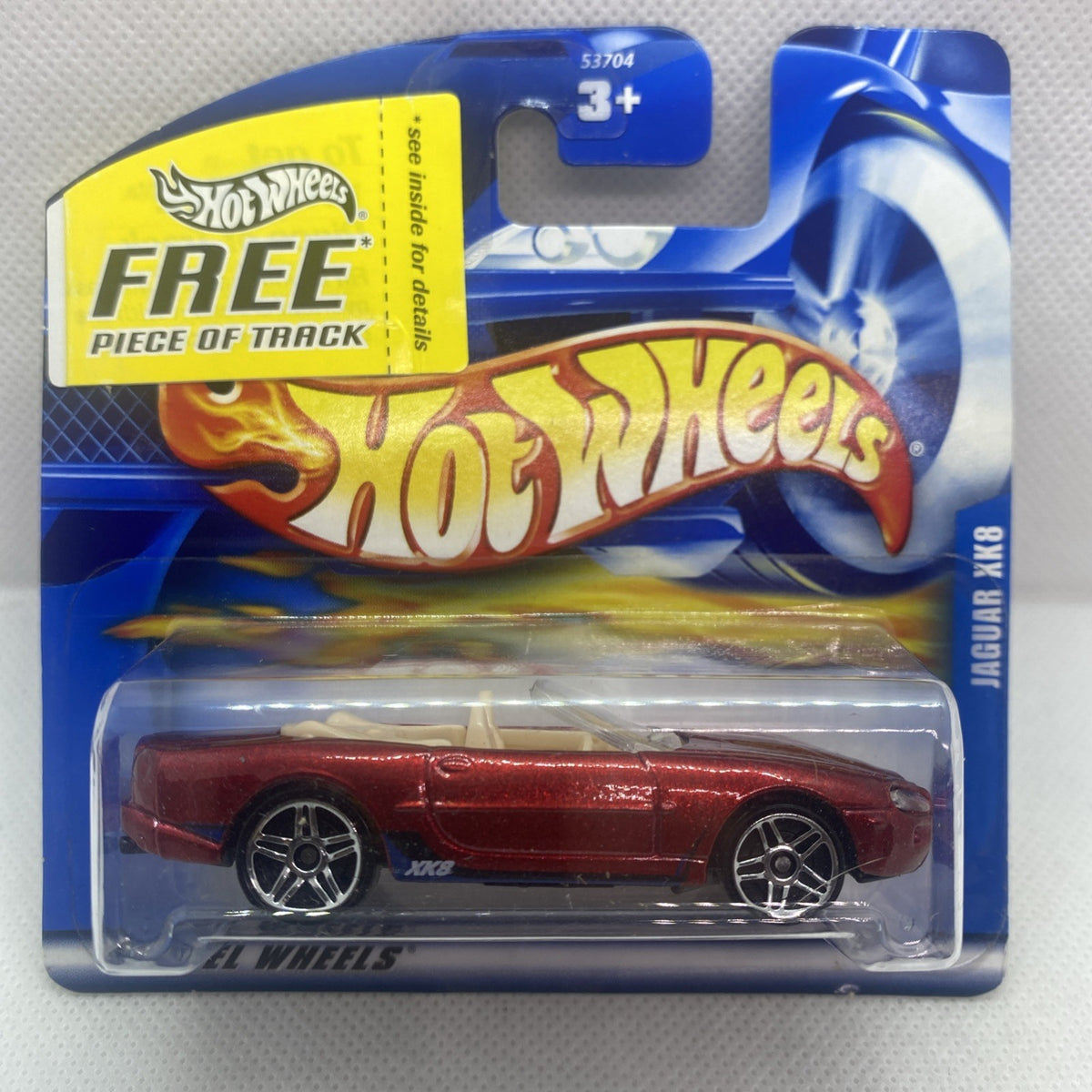Red die-cast Jaguar XK8 toy car in sealed Hot Wheels card with track piece