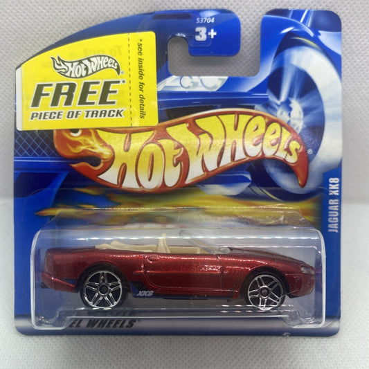 Red die-cast Jaguar XK8 toy car in sealed Hot Wheels card with track piece