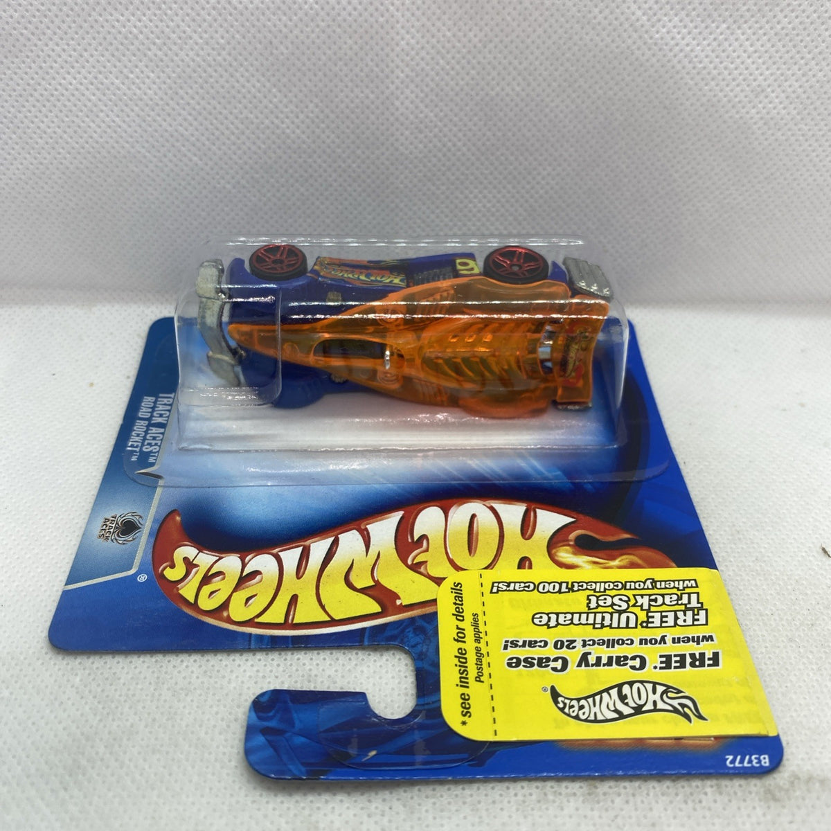 Hot Wheels Road Rocket die-cast car in blister on blue card, orange body
