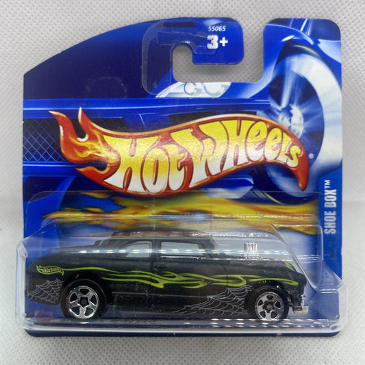 Hot Wheels die-cast car on blue blister card, black body with neon green flames