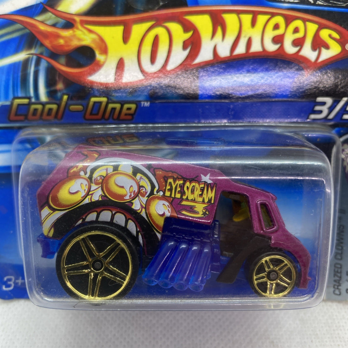 Hot Wheels Cool-One 2005 die-cast car close-up, magenta body with blue engine cover