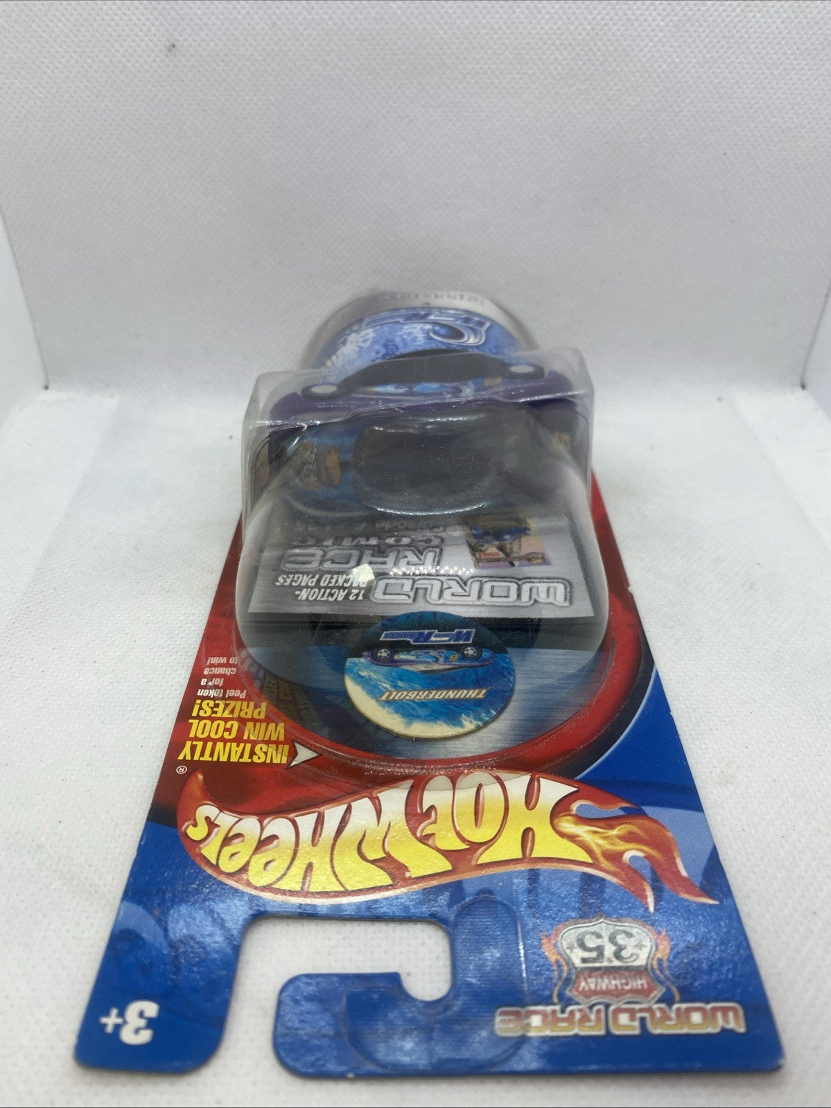 Hot Wheels World Race die-cast car in blister pack, top view