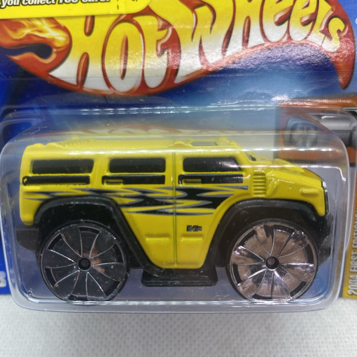 Hot Wheels yellow Hummer H2 2004 die-cast truck close-up in clear blister