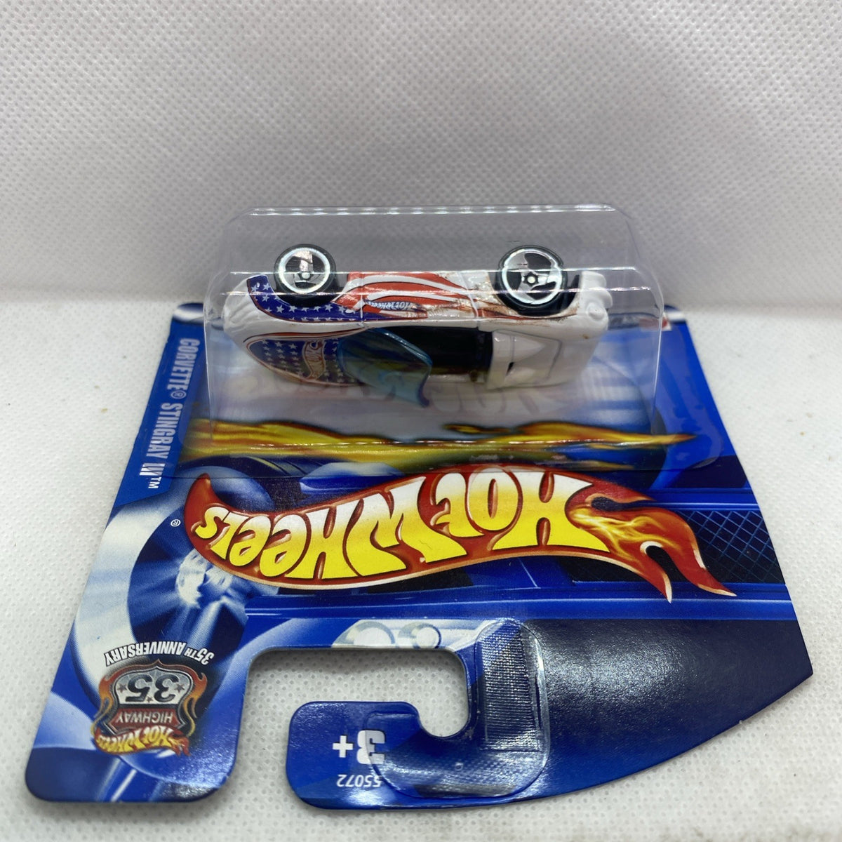 Hot Wheels Corvette die-cast in clear blister on blue short card, top view