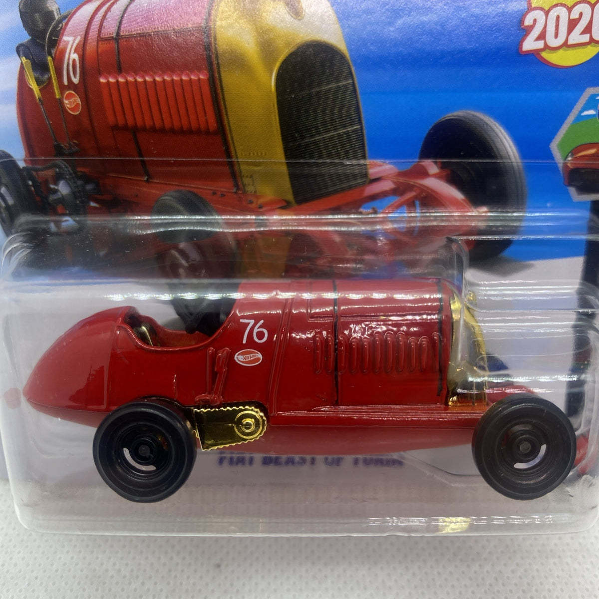 Hot Wheels red die-cast drop-top car close-up in clear blister