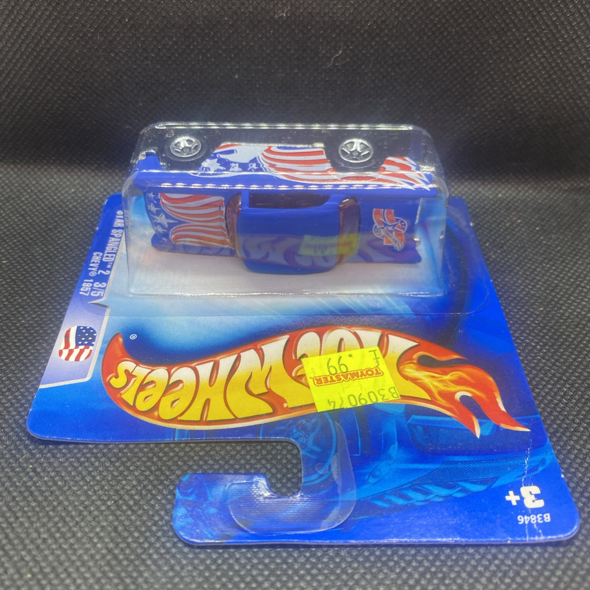 Hot Wheels 1957 Chevy die-cast on card, rear view with patriotic flame and stripes