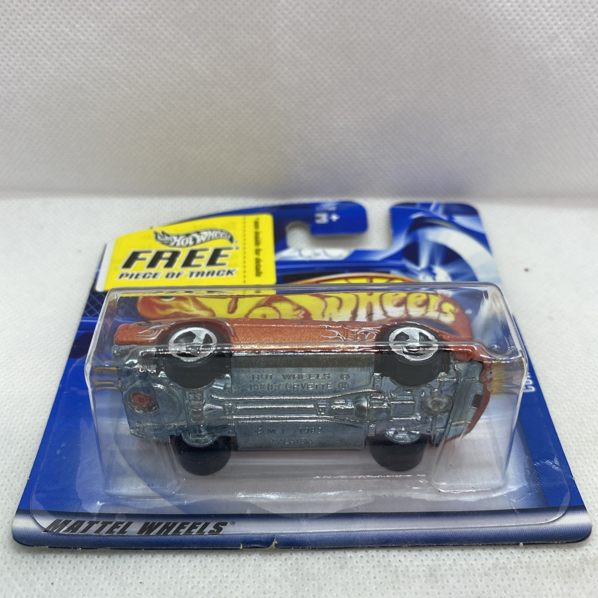 Orange die-cast Corvette toy car front view in clear blister on blue card