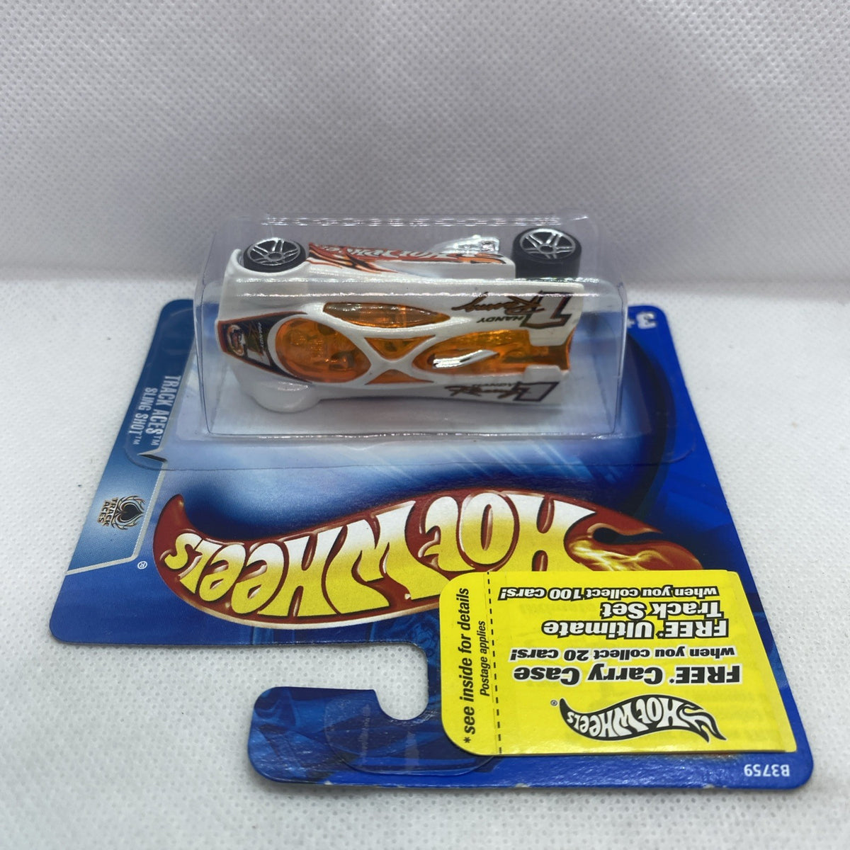 Toy car in clear blister on blue card, white body with orange accents