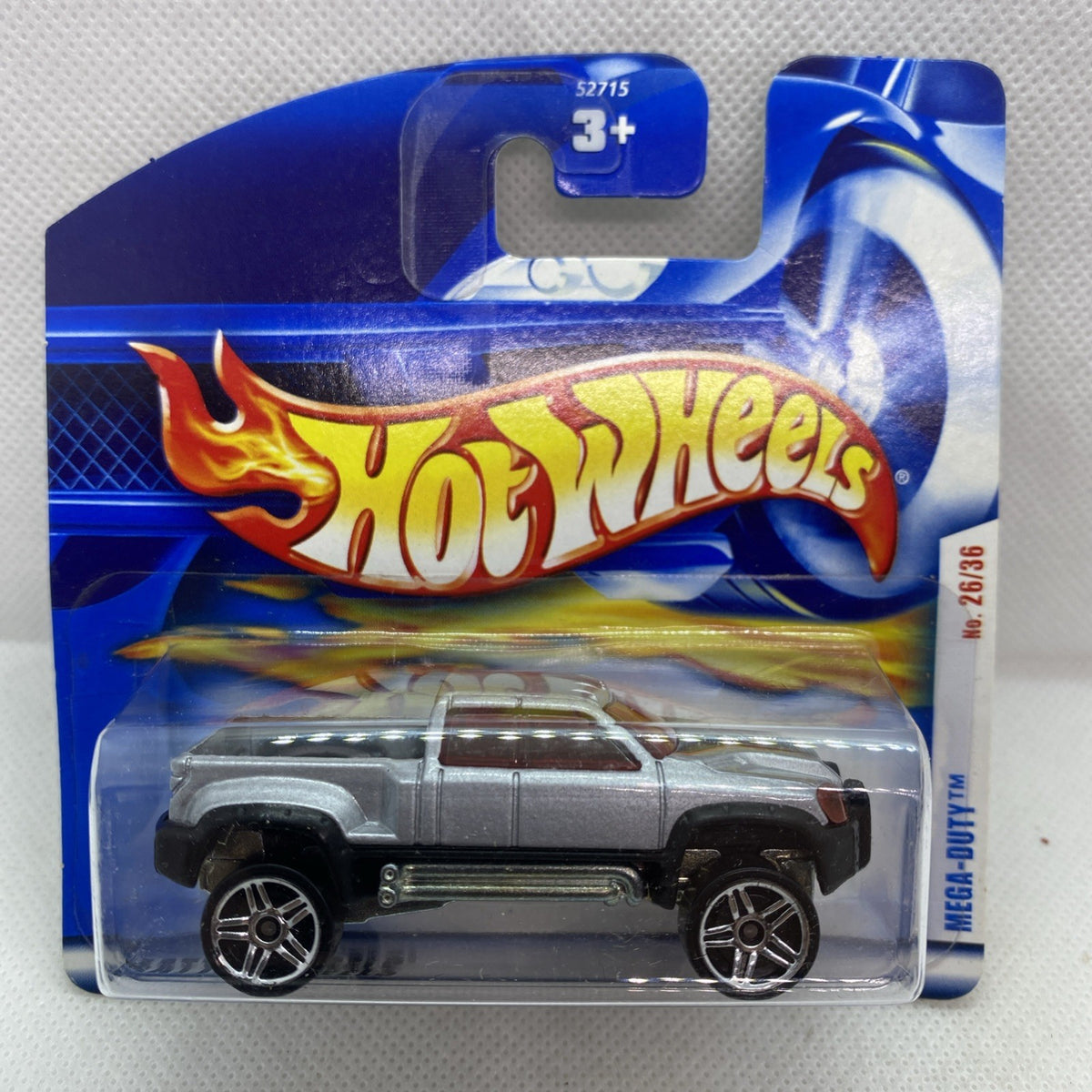 Silver Hot Wheels die-cast pickup truck with black wheels in blue blister card