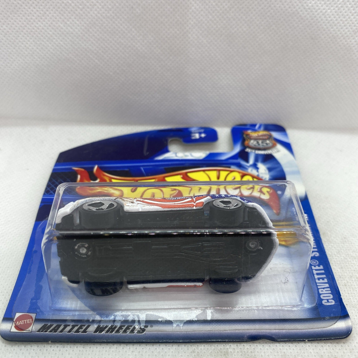 Hot Wheels Corvette die-cast in clear blister, blue short card backing visible