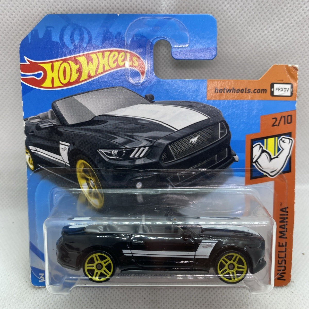 Hot Wheels die-cast black Mustang GT convertible toy in blister pack with yellow wheels