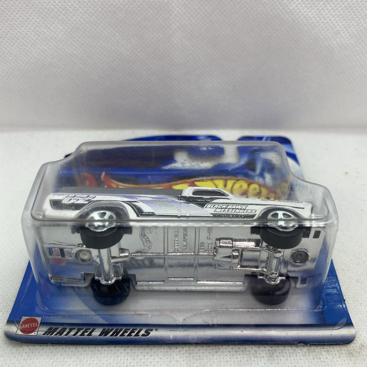 Hot Wheels die-cast pickup truck underside view in clear blister packaging