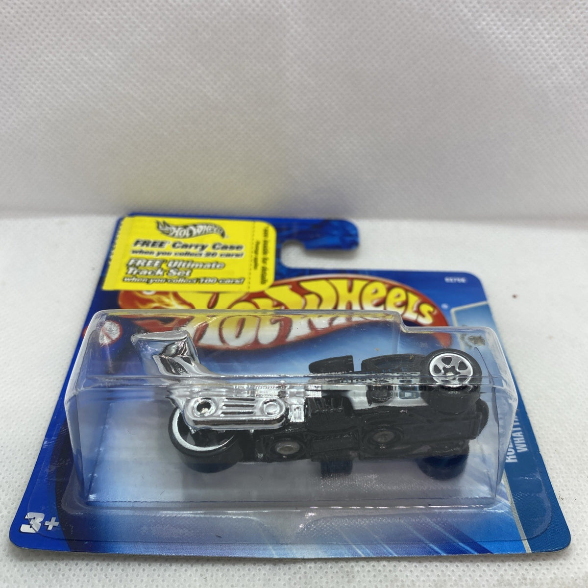 Hot Wheels die-cast toy car in blister on card, black with chrome trim and wheels