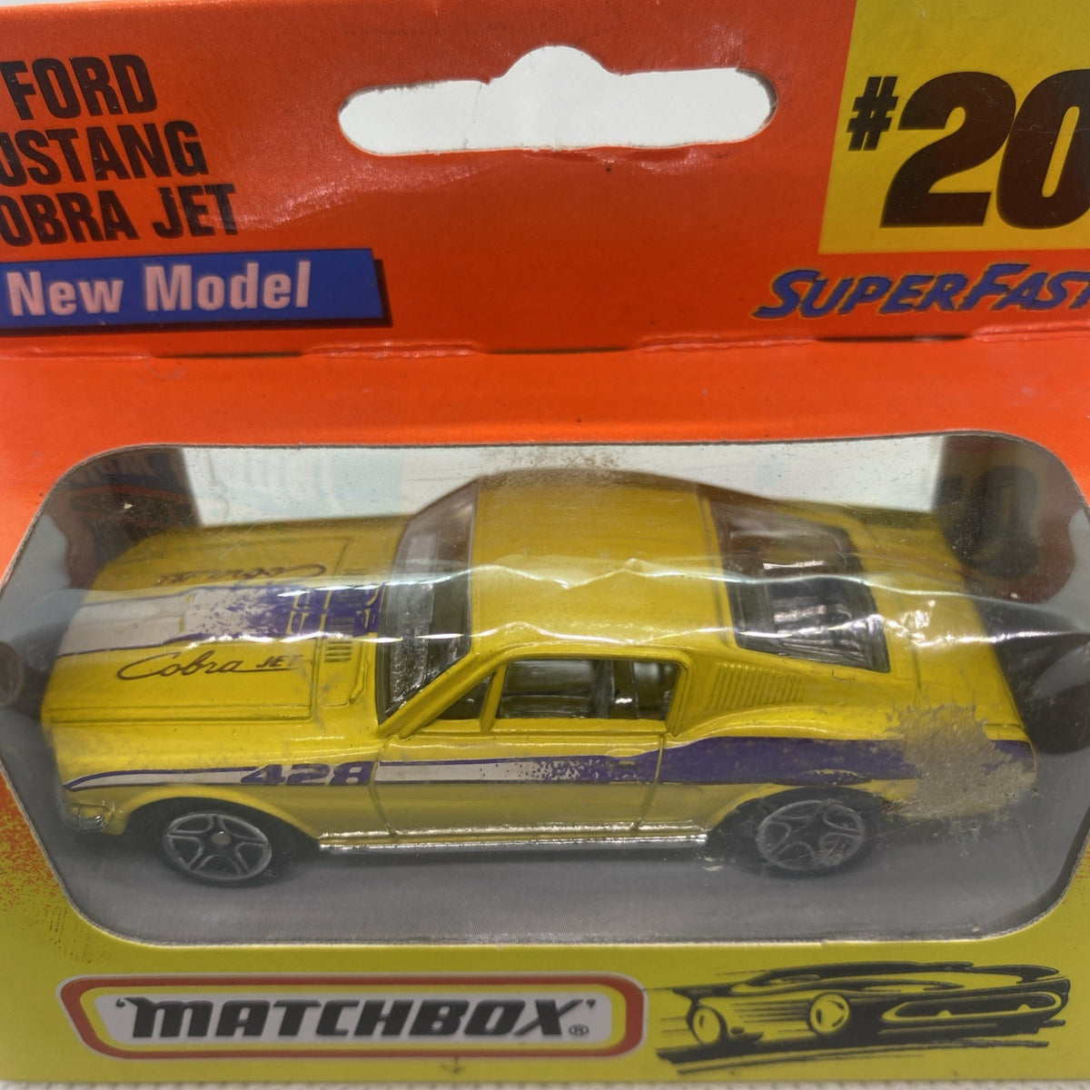 Boxed Matchbox die-cast yellow car model in clear blister, orange header top