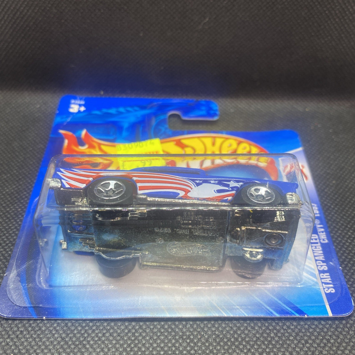 Hot Wheels 1957 Chevy die-cast on card, underside showing wheels and chassis