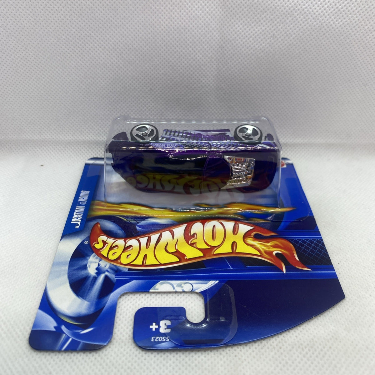 Hot Wheels die-cast car blister pack viewed from above, purple vehicle and blue card