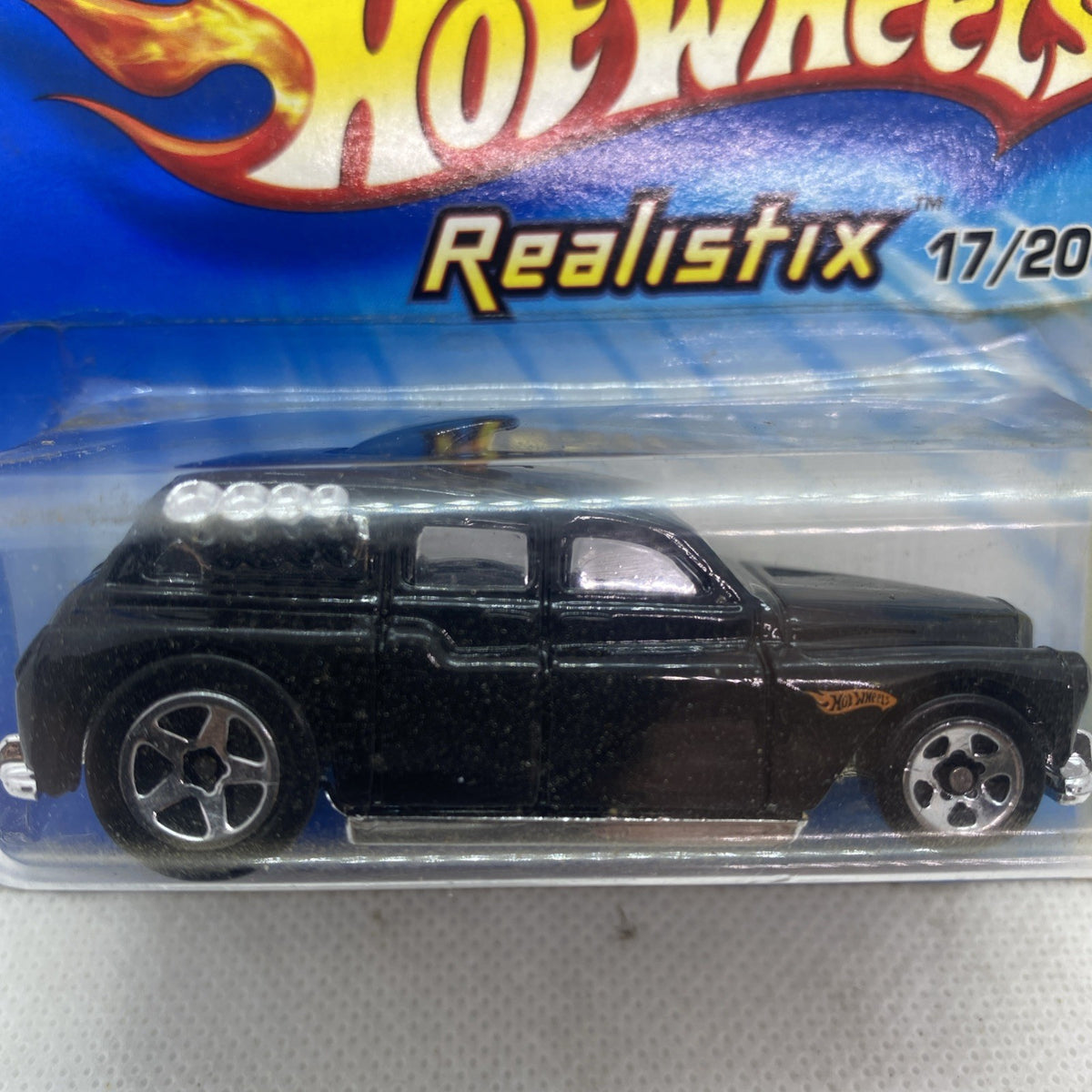 Hot Wheels black die-cast car close-up in clear blister with chrome wheels