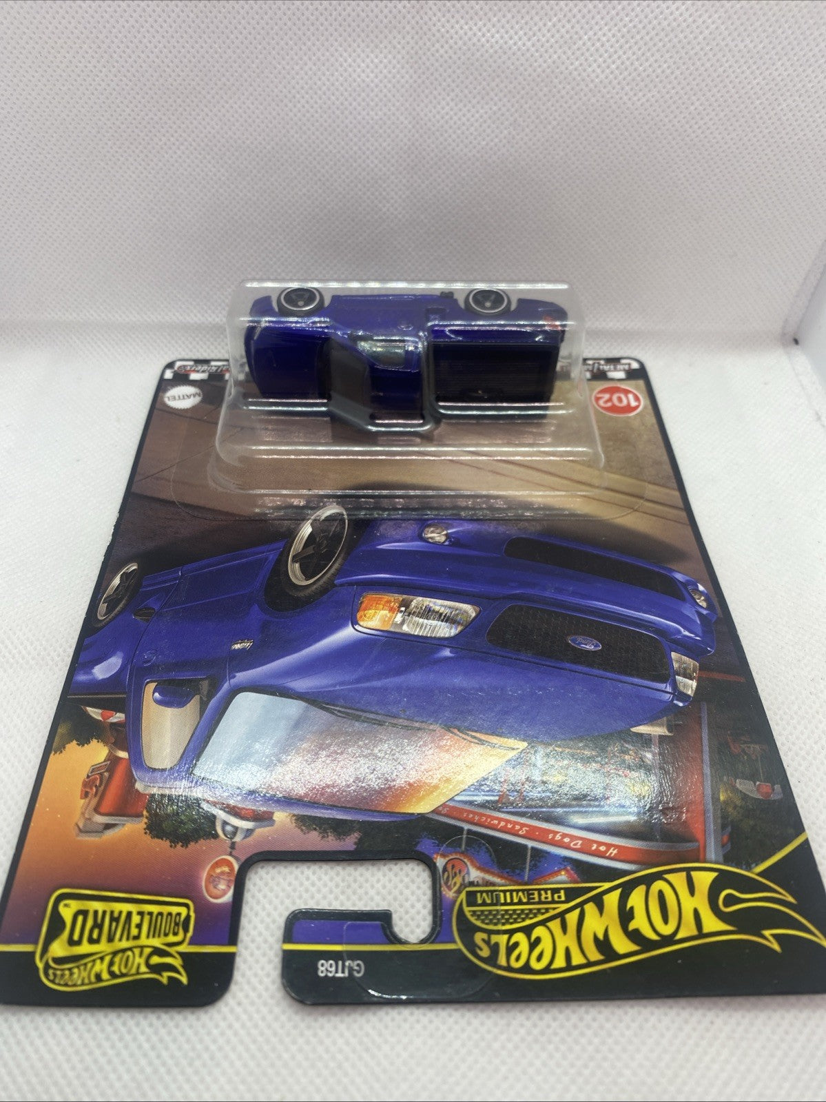 Blue F-150 SVT Lightning die-cast truck in blister, angled top view