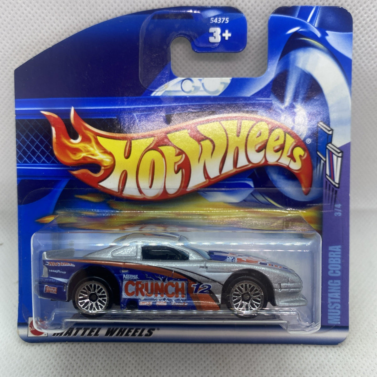 Hot Wheels die-cast car in blue blister packaging with silver sports car and flame graphics