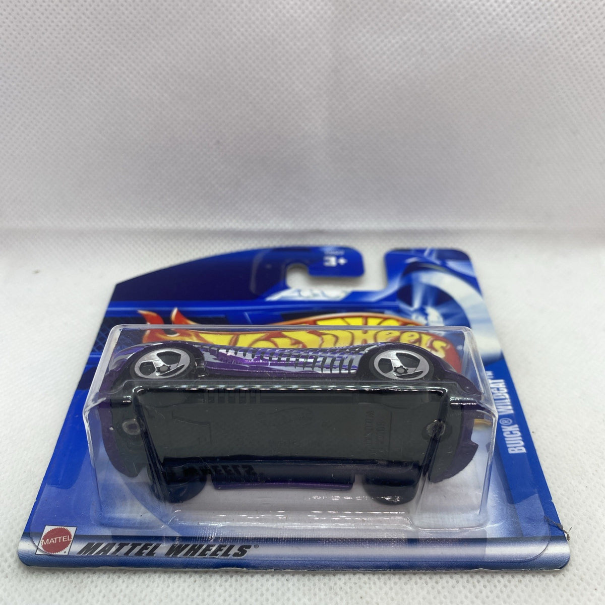 Hot Wheels die-cast car blister pack, purple model with black window and chrome wheels