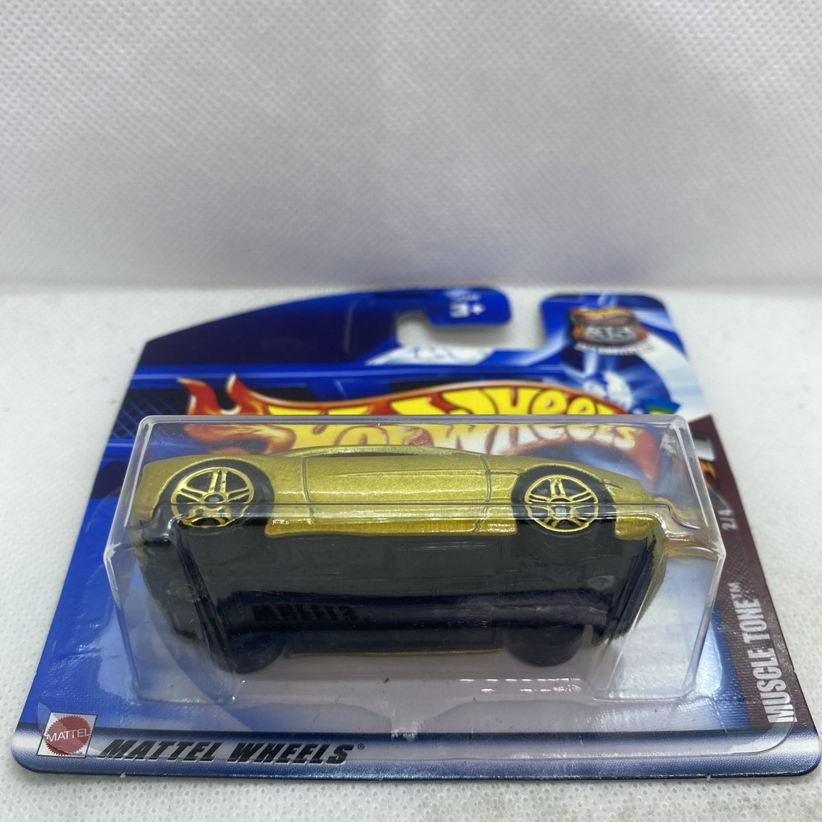 Hot Wheels muscle car toy in clear blister on blue backing, side view
