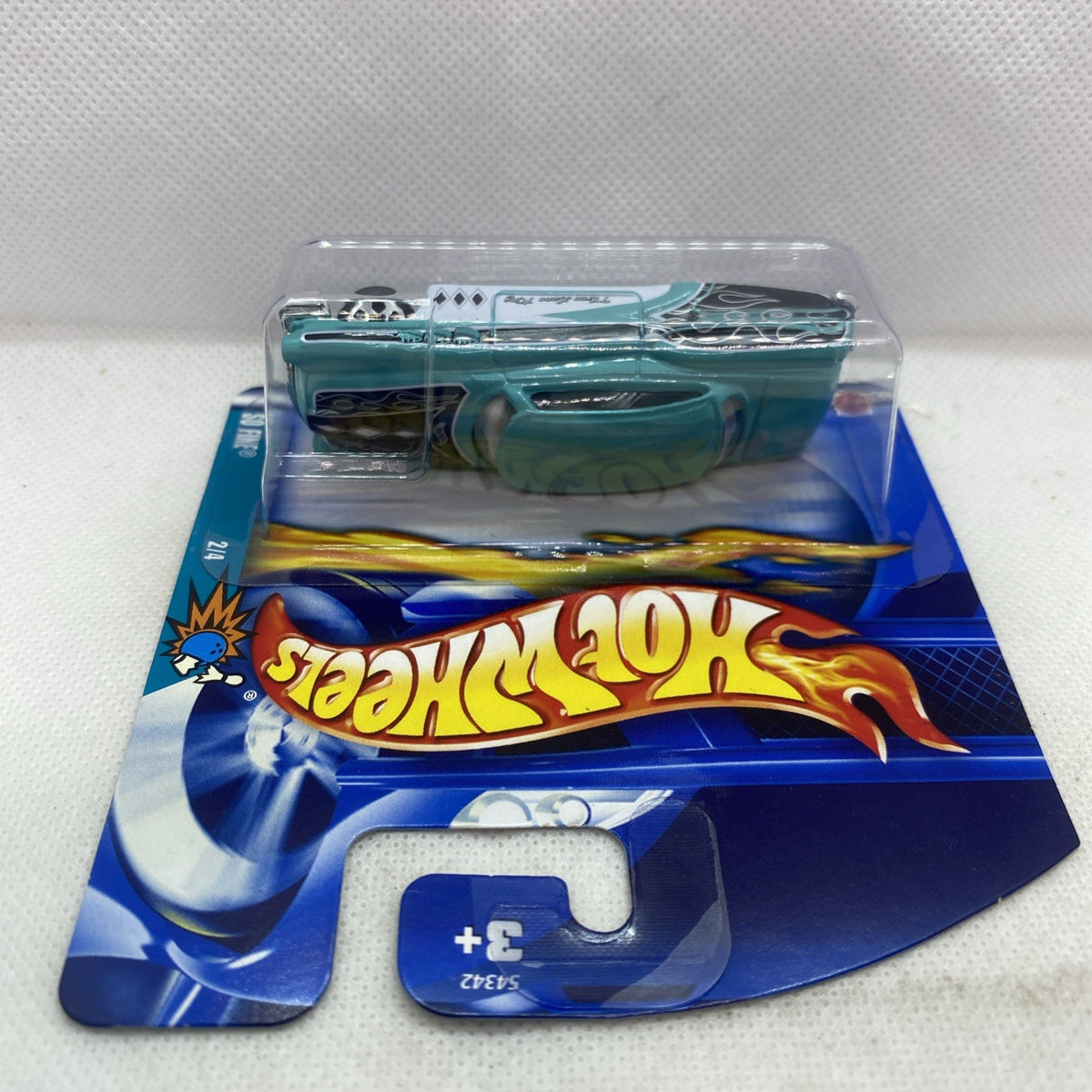 Teal die-cast truck in clear blister on blue short card with Hot Wheels logo