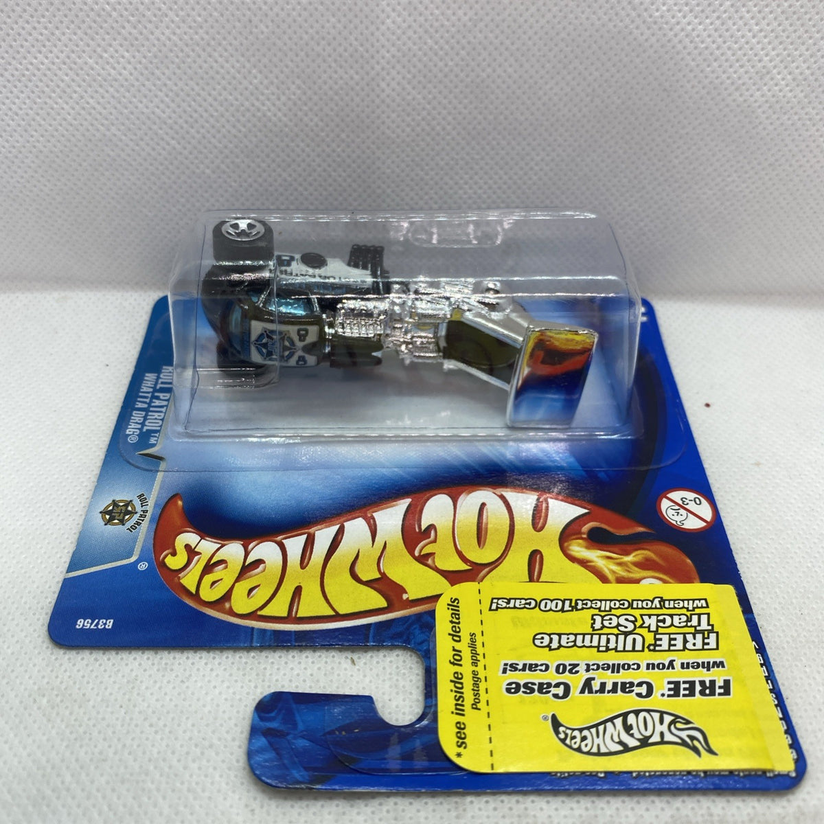 Hot Wheels die-cast toy car blister pack, black car with chrome engine parts