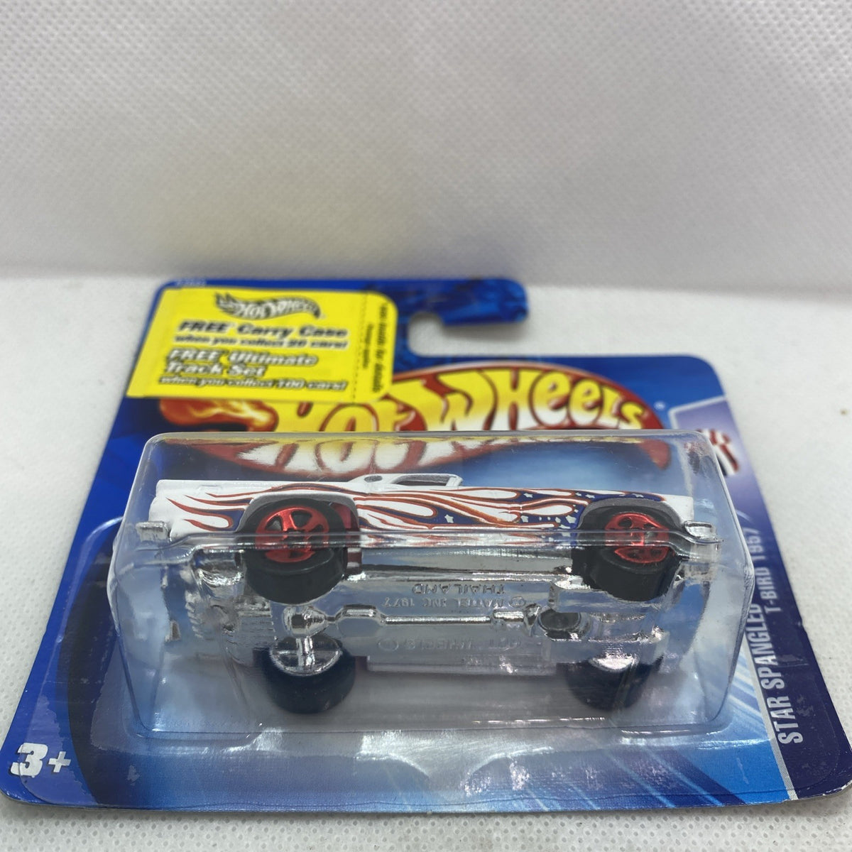 Hot Wheels T-Bird die-cast car in clear blister on blue card, white flame paint and red rims
