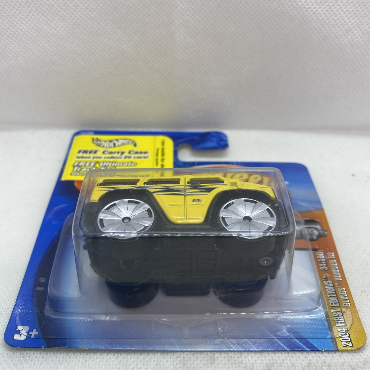 Hot Wheels yellow Hummer H2 2004 die-cast truck in blister pack, side view
