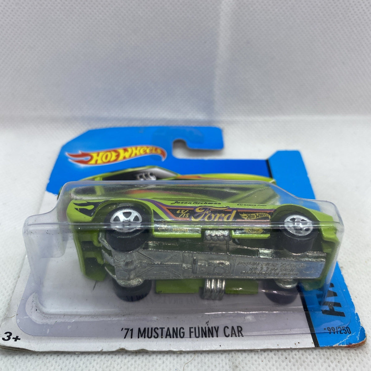 Hot Wheels die-cast car in blister packaging, lime green with Ford logo and decals