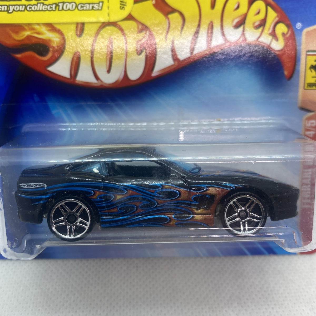 Hot Wheels Ferrari 550 Maranello close-up: black body with blue flame stripes, front wheels