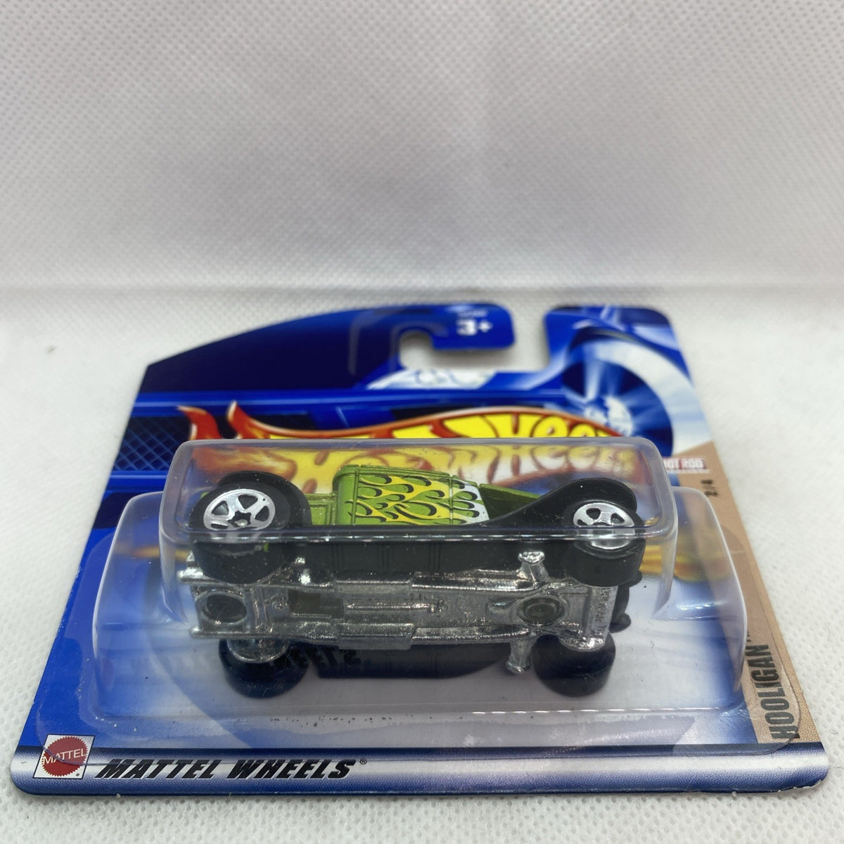 Hot Wheels Hooligan Hot Rod die-cast car in clear blister, side view with green flame panel.