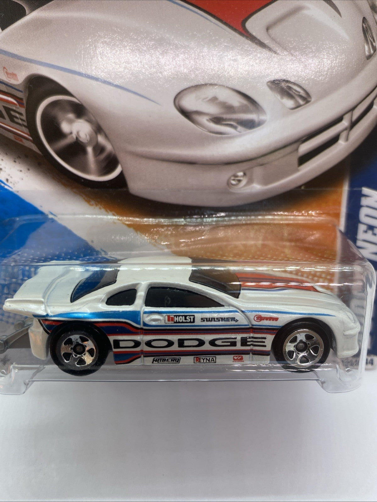 Side view of white dragster diecast with blue and orange racing stripe in blister