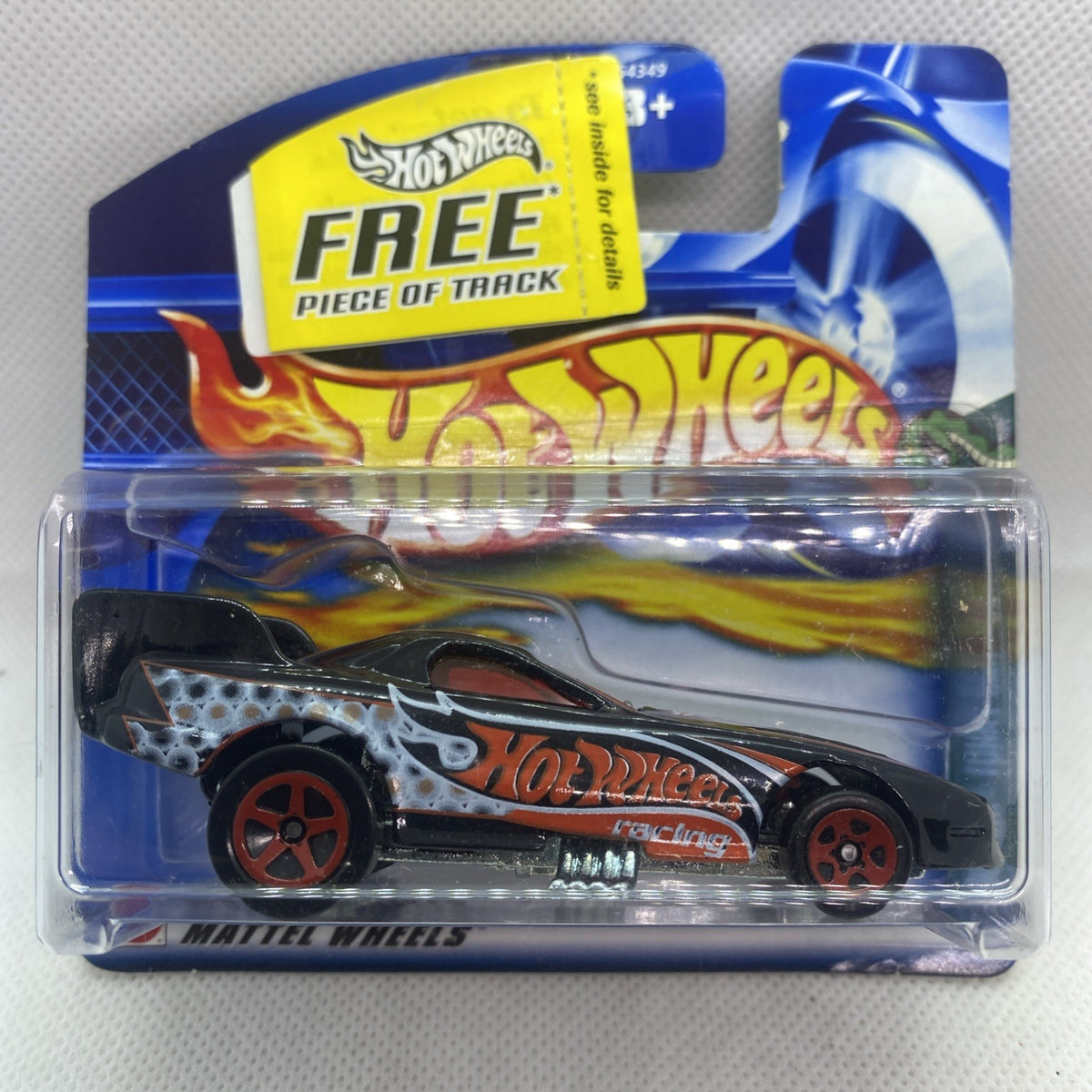 Hot Wheels Funny Car die-cast toy in clear blister, black body with flame graphics.