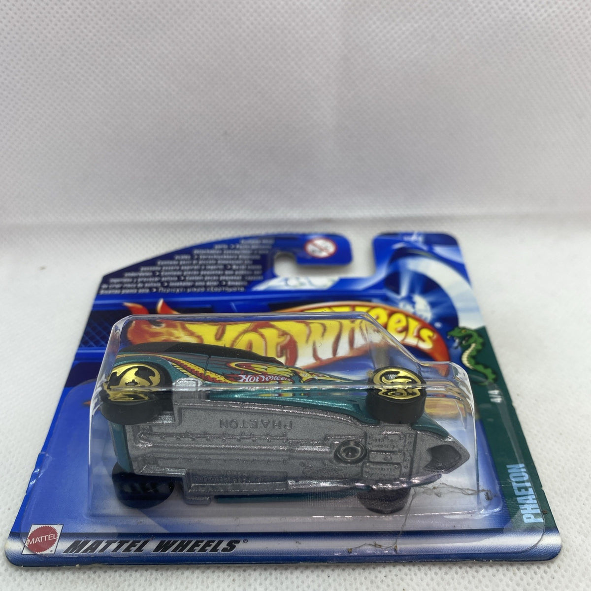Hot Wheels die-cast car in blue blister card, teal muscle car with flame decals