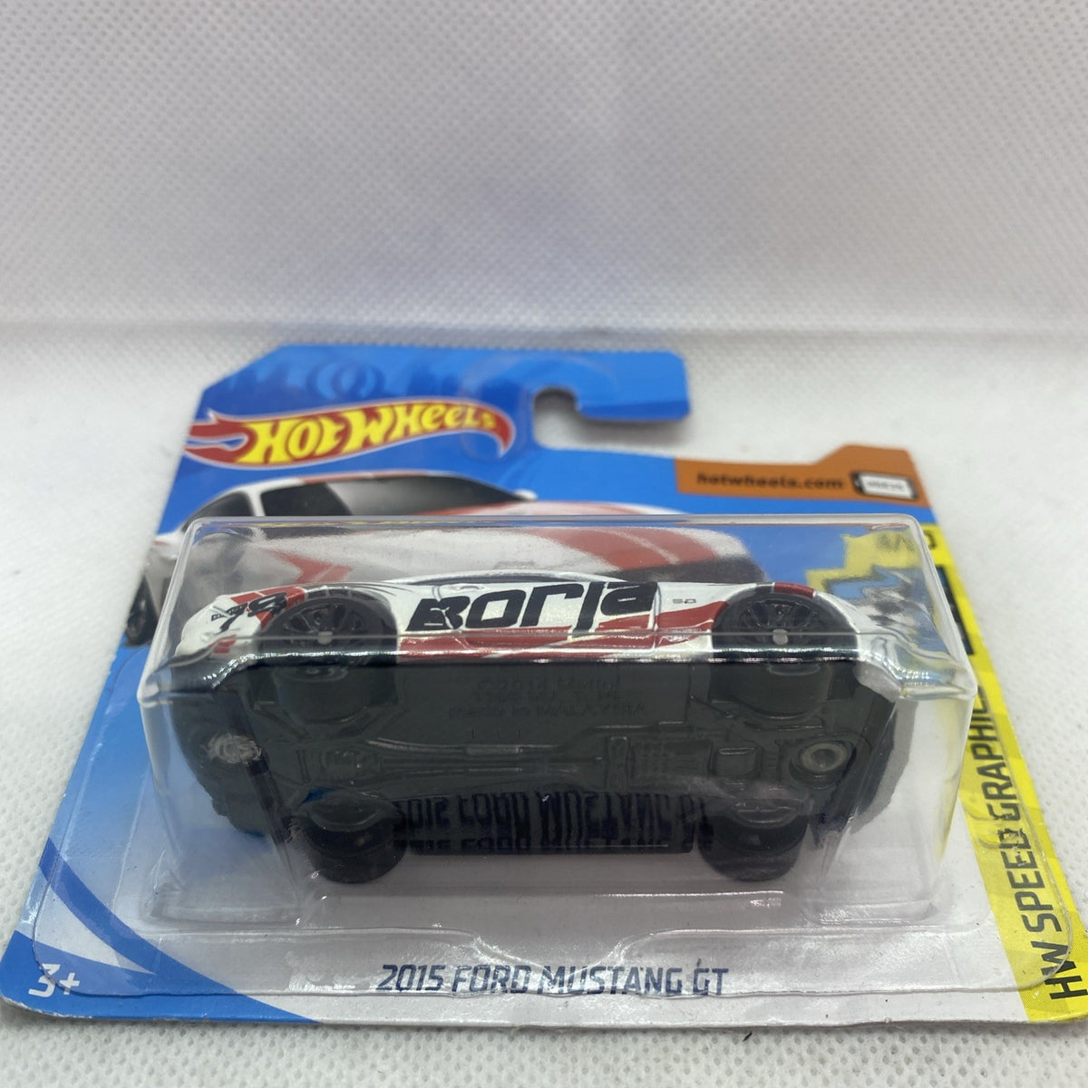 Hot Wheels Speed Graphics blister pack showing a white and red die-cast Mustang GT car