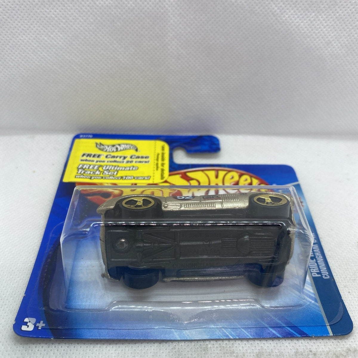 Hot Wheels die-cast race car in blister pack, rear view on card backing