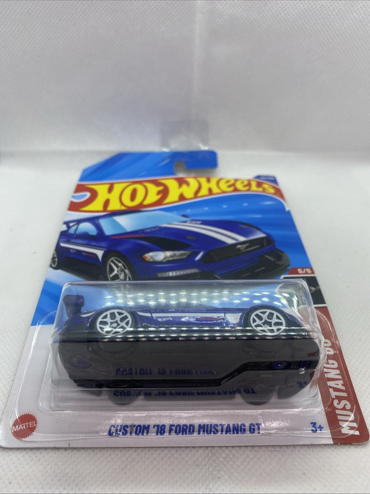Hot Wheels sealed blue die-cast car on short card with clear front window