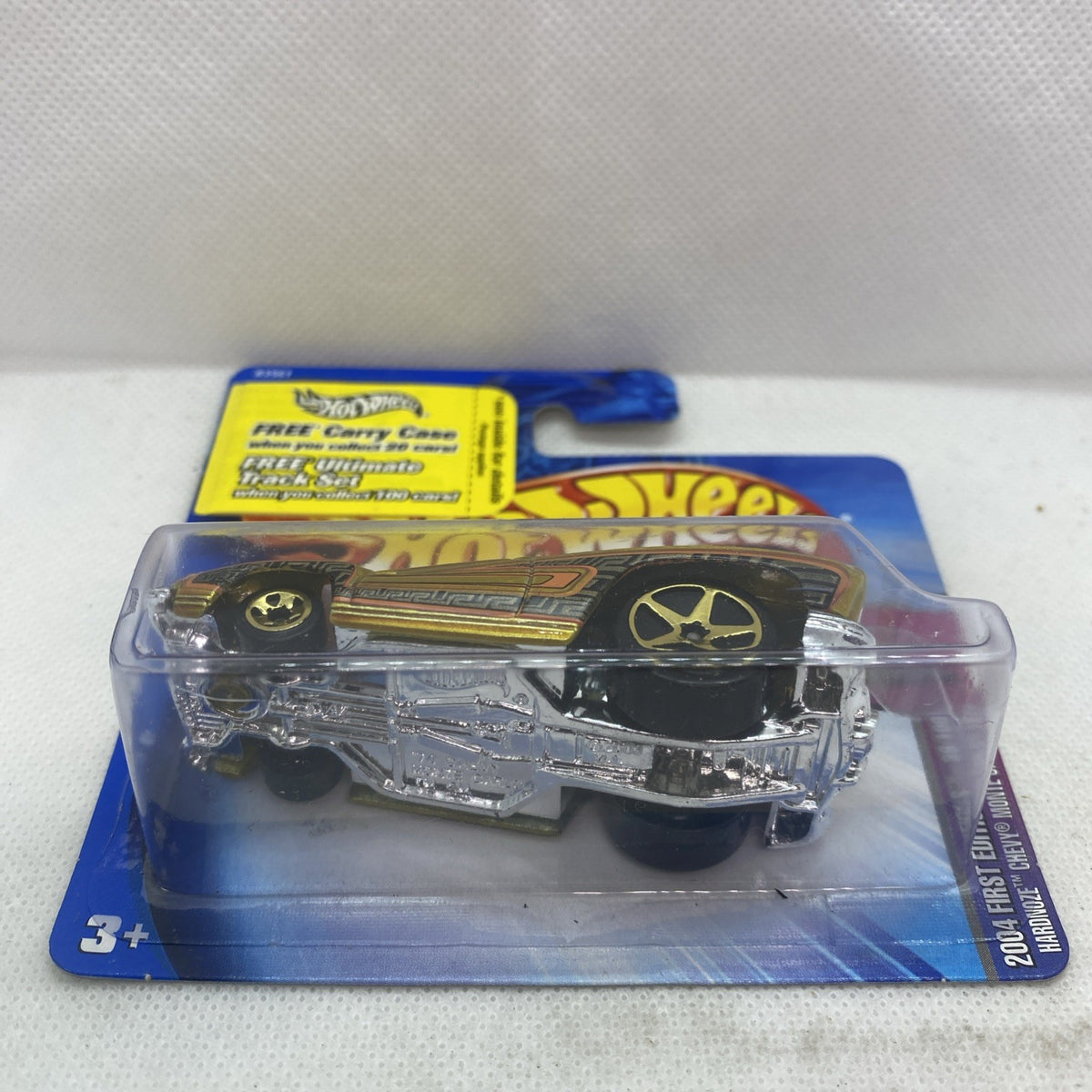 Hot Wheels die-cast car blister on blue card, yellow body with chrome front details
