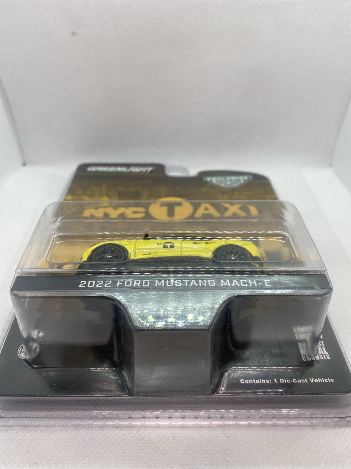 Yellow NYC Taxi die-cast car model in clear blister, front-on view.