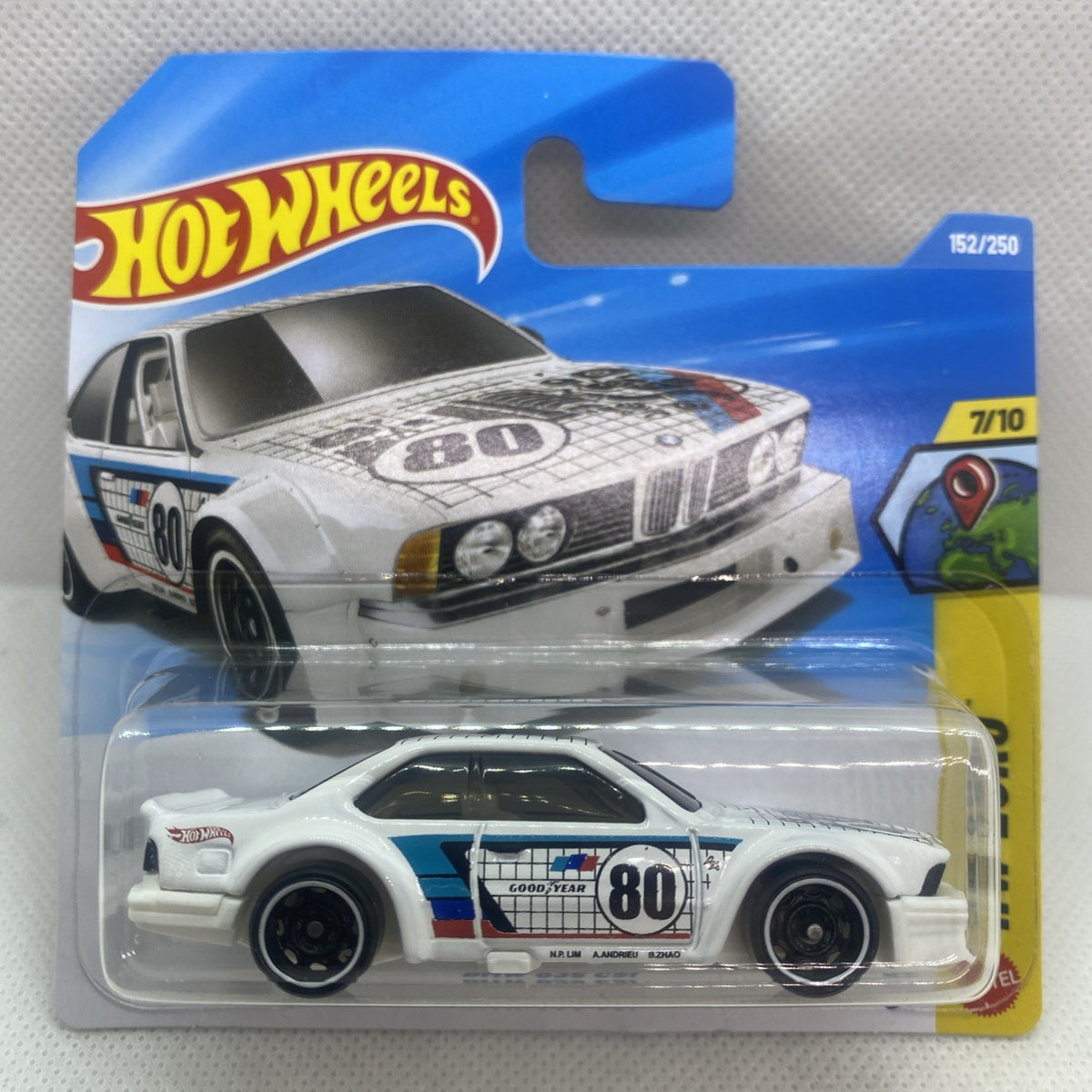 White die-cast car with blue racing stripe, number 80, in clear blister pack