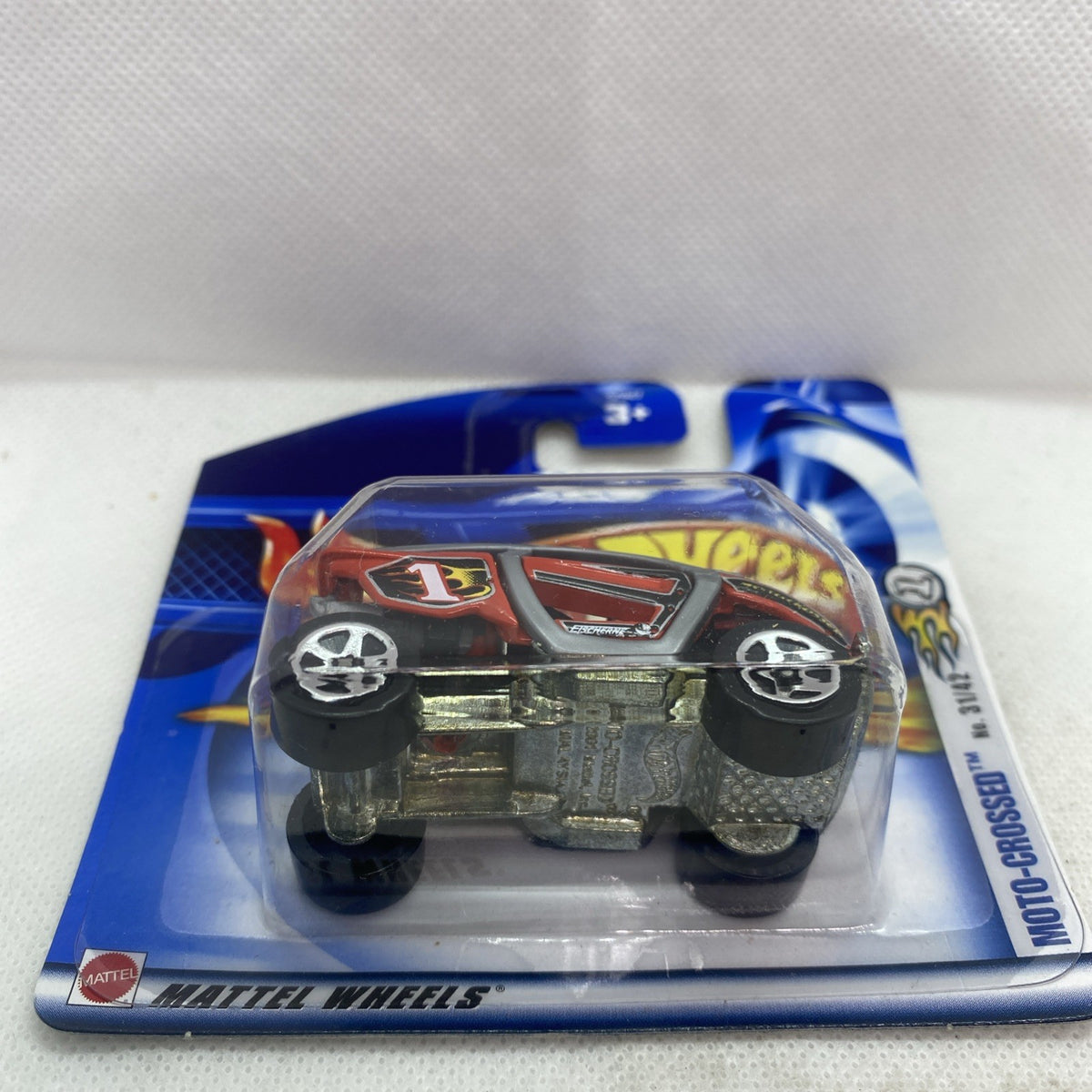 Hot Wheels blister card with die-cast motocross car and wheels visible through clear window