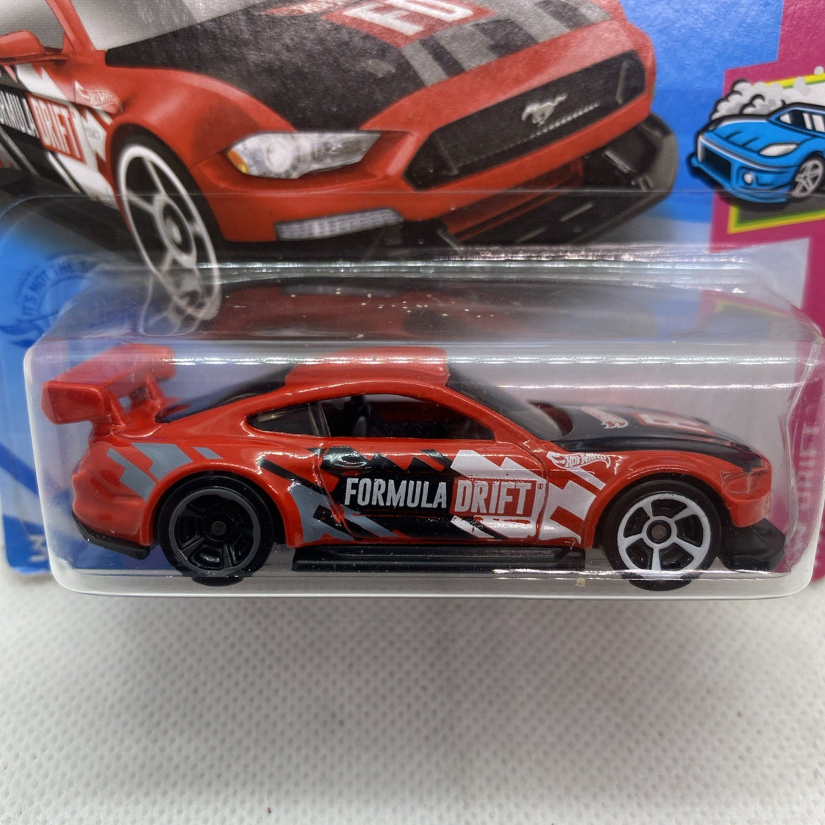 Hot Wheels Formula Drift orange die-cast car with white decal, sealed in plastic