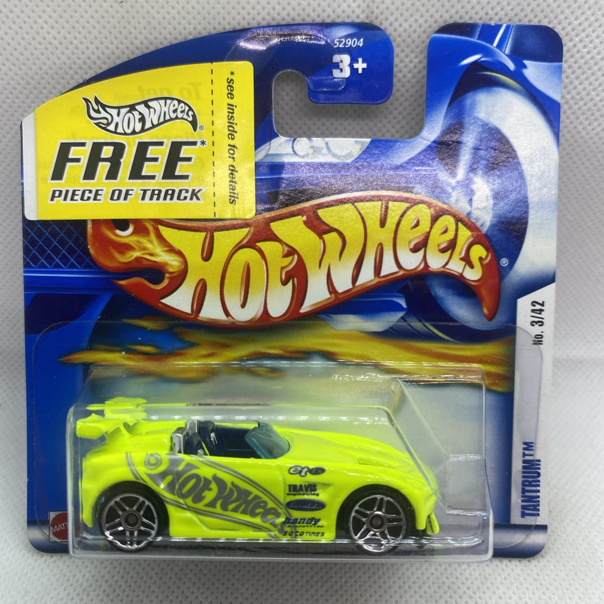 Hot Wheels carded neon lime die-cast car in clear blister on blue backing
