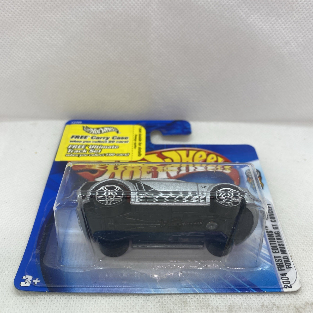 Hot Wheels die-cast car in clear blister on card, silver/gray body with black accents