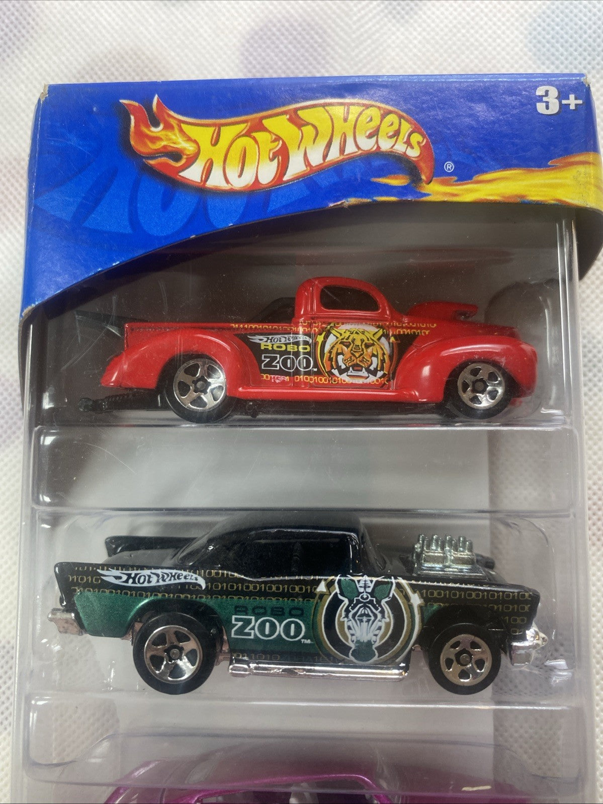 Diecast red and green cars in clear blister pack with Robo Zoo graphics