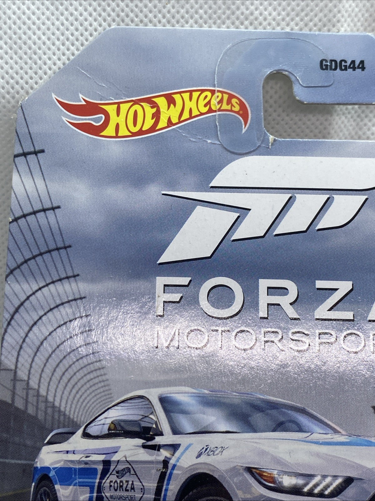 Hot Wheels Forza Motorsport card with logo and blister window showing white and blue car