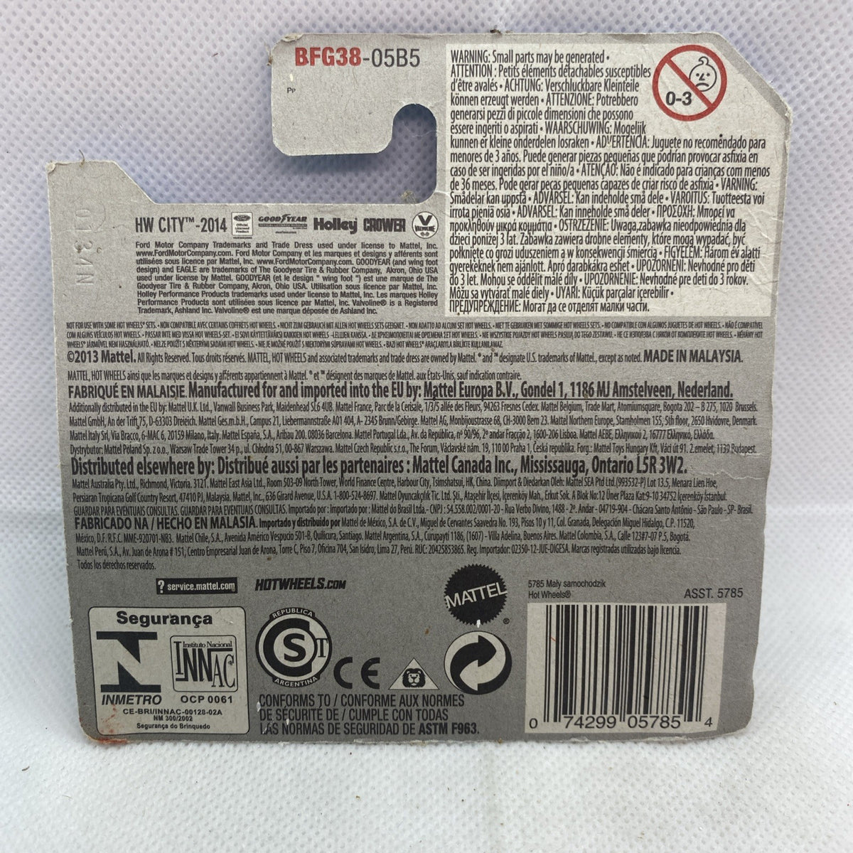 Toy car package back card with barcode, safety icons, and product information label