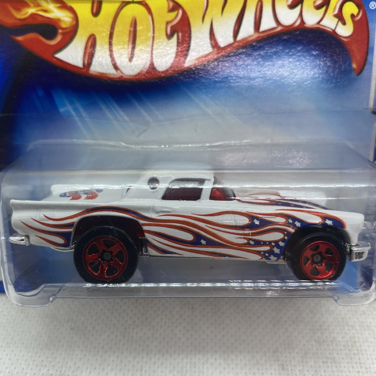 Hot Wheels T-Bird die-cast car close-up, white flame graphics, red wheels, in sealed plastic